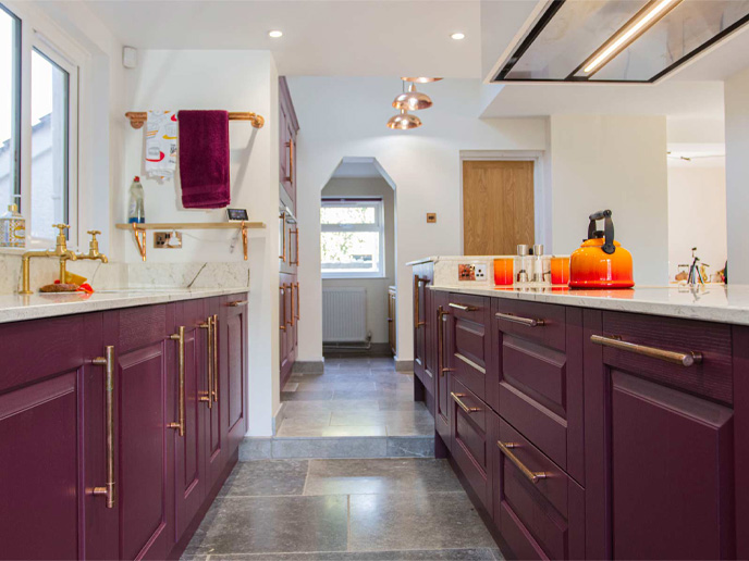 A mid-century design kitchen featuring red cabinets and over-the-top dÃ©cor
